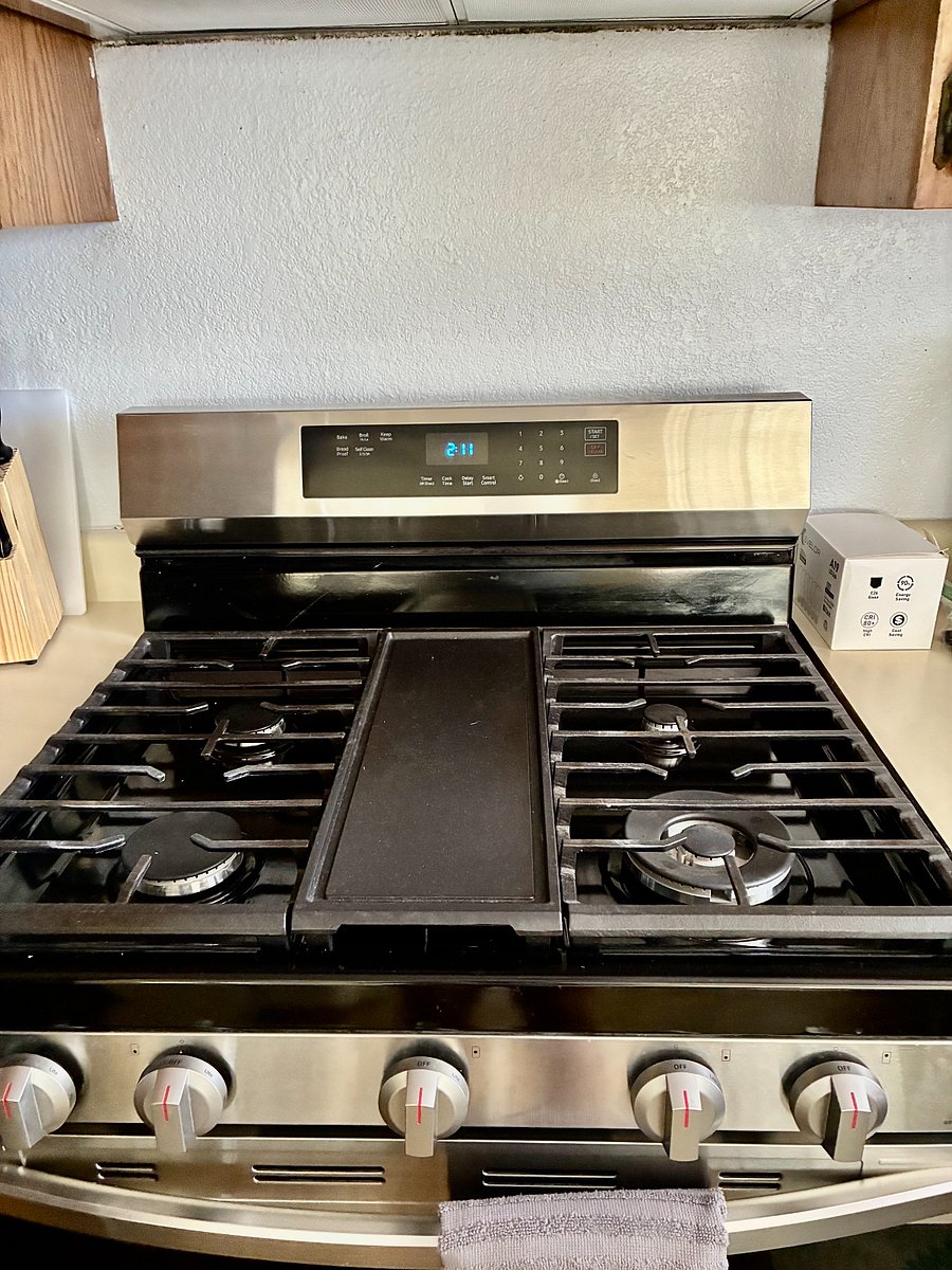 New Gas Cooking stove and oven. Cookie sheets and baking pans.