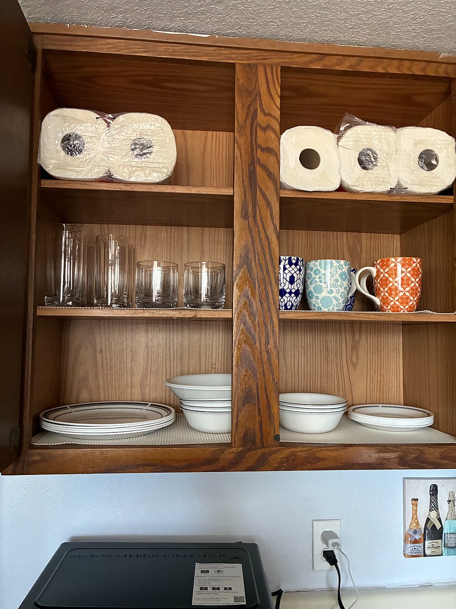 Corelle plates and bowl and plenty of cheerful mugs. Glasses tall and short