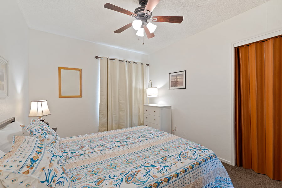Master bedroom with 3 drawer dresser, blackout curtains and closet with folding doors. Includes Iron, short ironing board and hangers. Carpeted