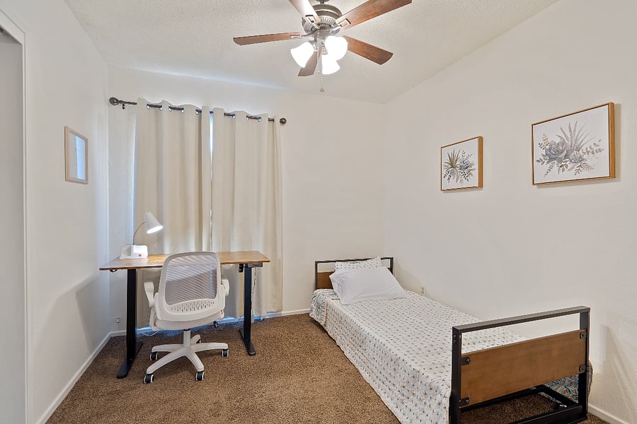 Bedroom #2 with 100% blackout curtains. fan and ceiling light . Also desk lamp with charging ports.