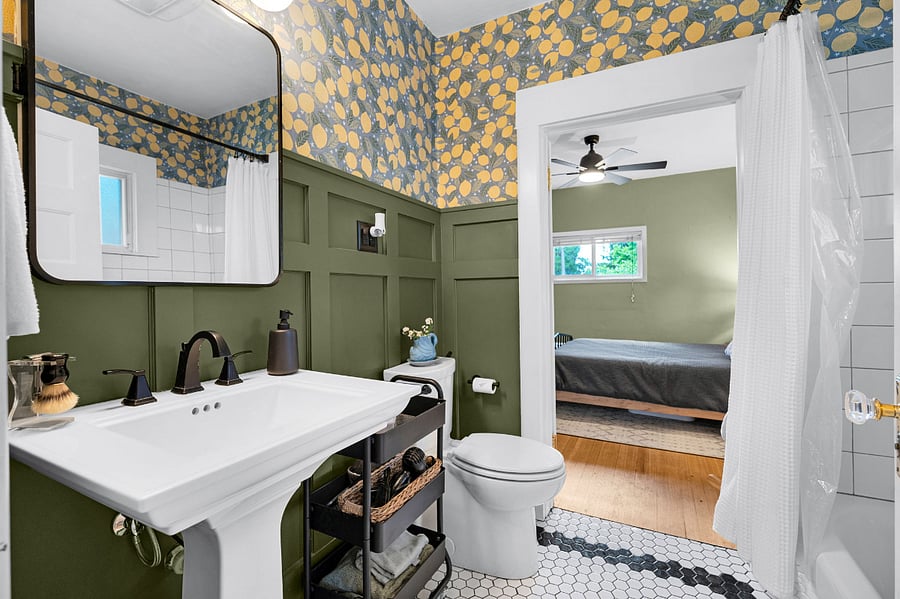 Bathroom (jack-and-jill style between both bedrooms) has a toilet, sink, built-in medicine cabinets, built in shelving (next to the shower), shower/tub and storage cart.