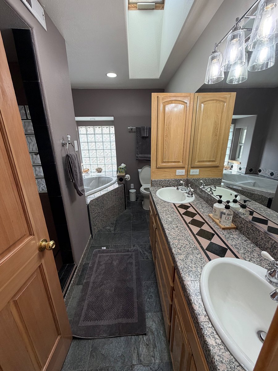 primary en suite with separate shower with 2 shower heads, jetted tub, dual vanity, linen closet. Towels provided