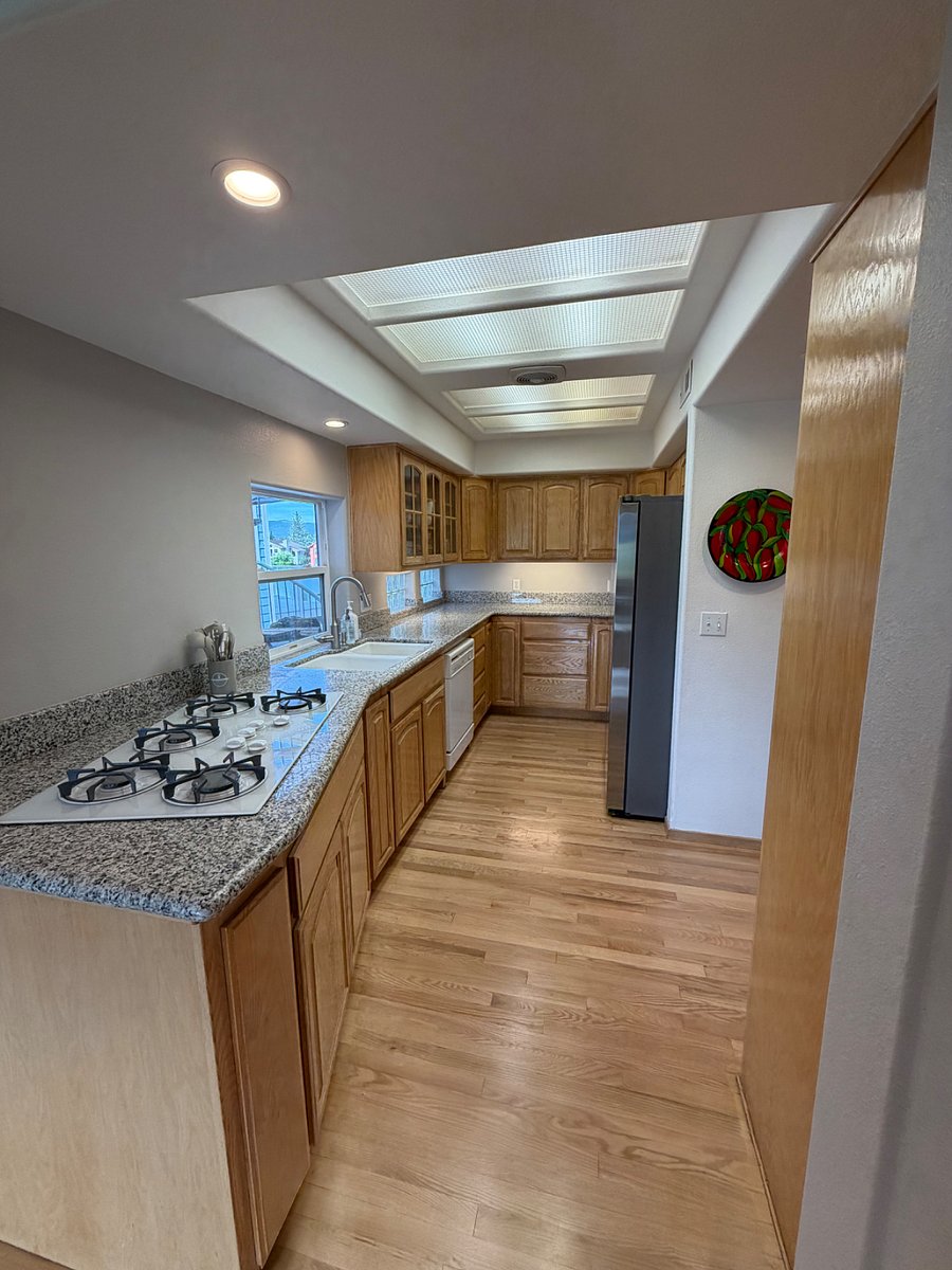 galley kitchen with full size fridge/freezer, microwave, oven, gas cooktop. There is a natural gas bbq just outside too!