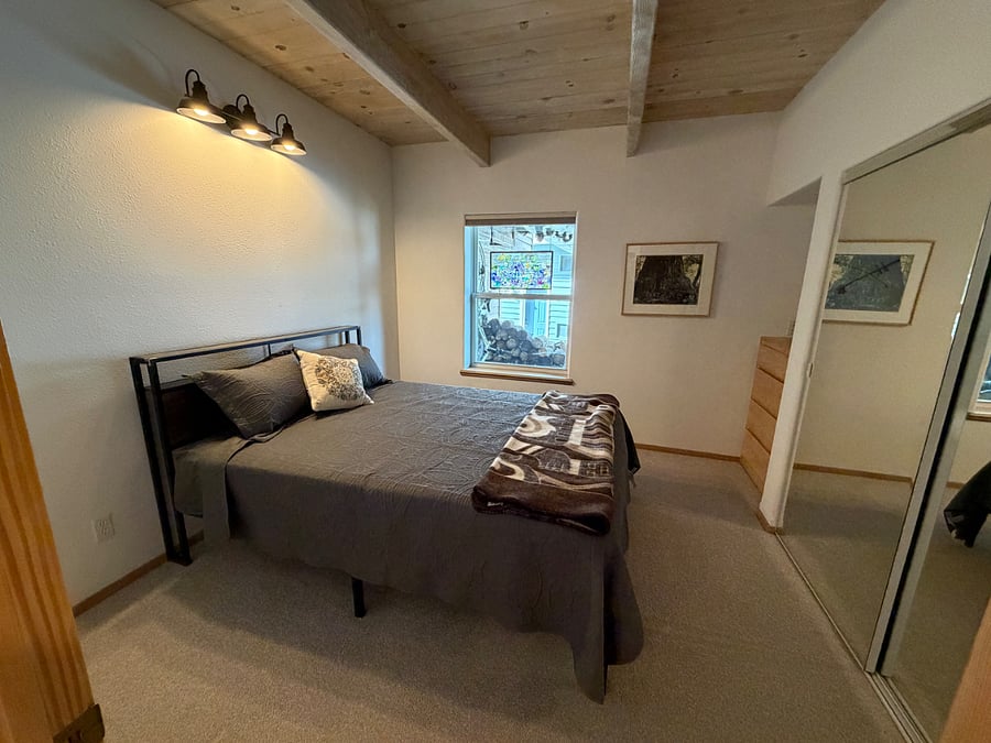 downstairs bedroom with double bed, built in dresser, large closet