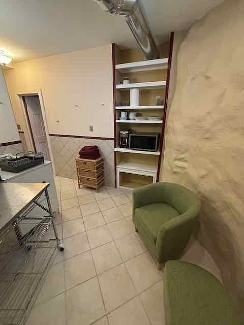 Built-in storage includes outlets for microwave, coffee maker; unit includes dishes/utensils.