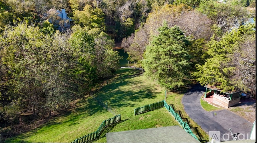 back yard with seasonal lake view and outdoor kitchen