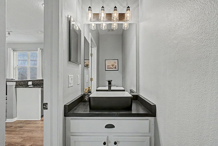 Downstairs half bath with new fixtures, sink, and counter