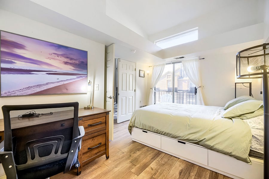 Downstairs Bedroom with desk and 20' ceilings