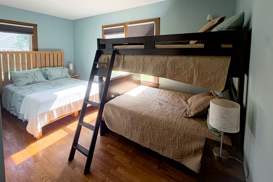 The second bedroom sleeps four a queen and a full bunk, which means there's always room to share Brevard with family or friends. Blackout shades, original hardwood floors, and enough space that nobody feels crowded.