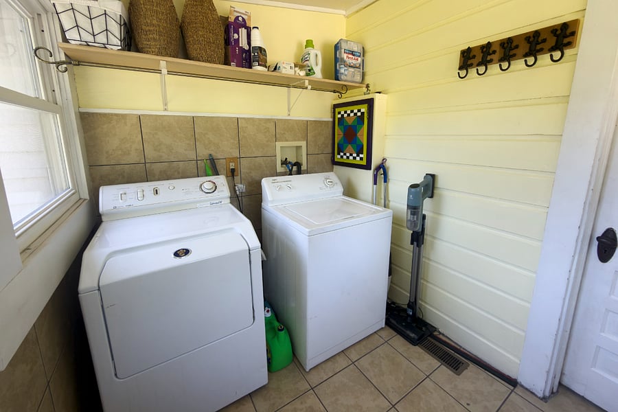 Full size washer and dryer right off the kitchen a hanging rod above for straight-out-of-the-dryer clothes, and gear hooks on the wall for when you come in from the trail.