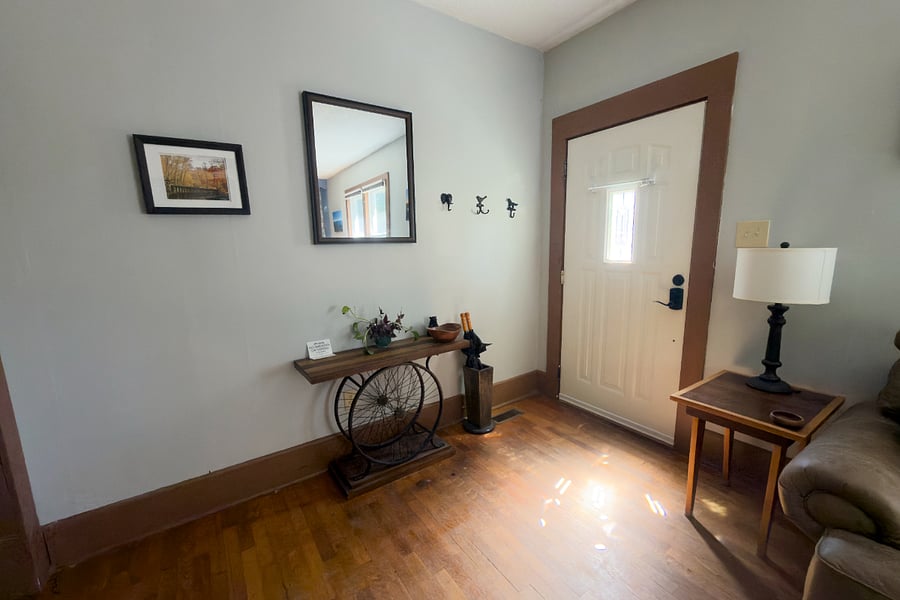 The entryway sets the tone coat hooks for your gear, a mirror for a quick check before you head out, and a bicycle wheel console that nods to Brevard's trail culture. Original trim and doors throughout