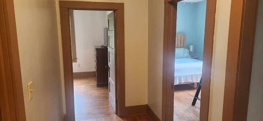 Original trim and doors throughout the hallway connects the bedrooms without a wasted inch.