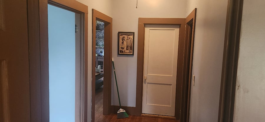 Original trim and doors throughout guest bathroom straight ahead, office to the right, living room to the left. Everything connects without a wasted step.