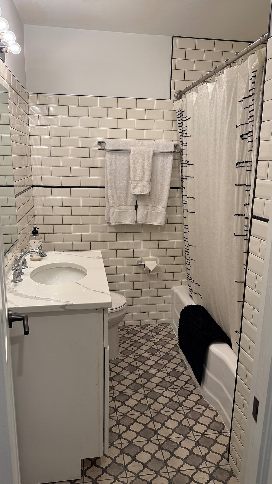 Bathroom with shower/tub combo with small linen/toiletry closet.