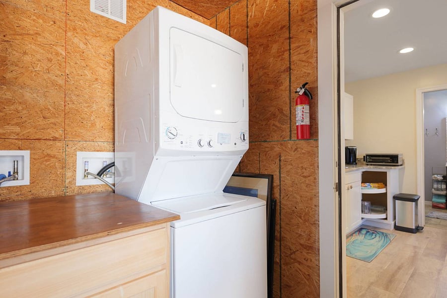 Garage washer/dryer stackable unit for use.  There is also another washer/dryer that is larger next to the stackable for use. 