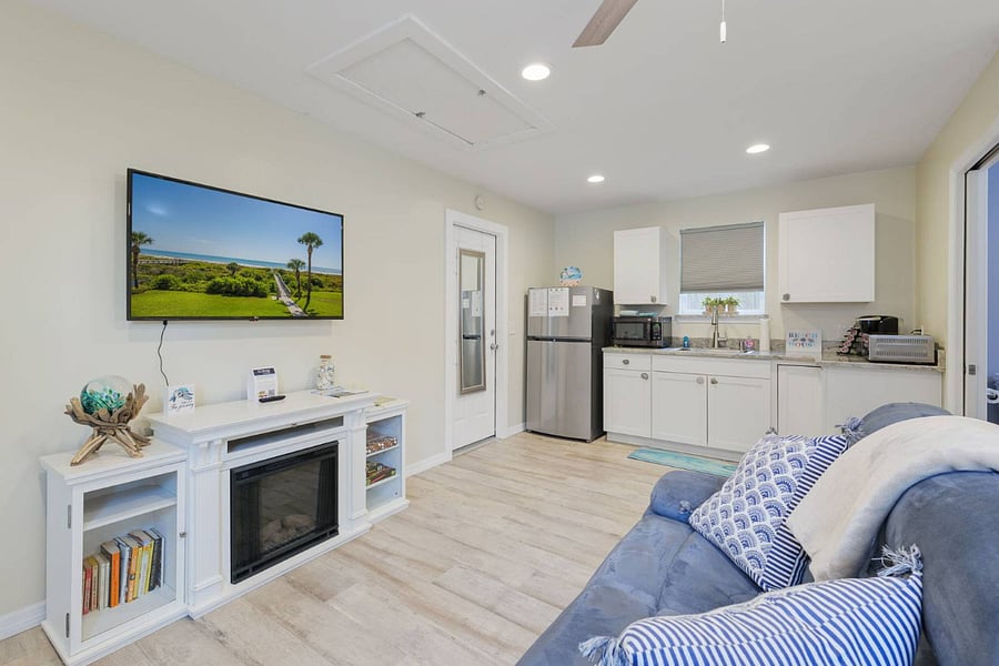 Living area with fireplace and love seat. Smart tv to stream your shows! 