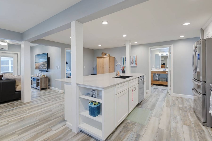 Open kitchen with the bathroom on the far side.
