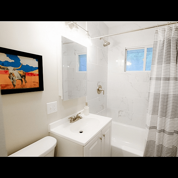Fully stocked full bath with large storage cabinet for towels and personal items.