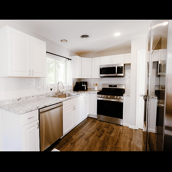 Fully stocked kitchen with nice window overlooking backyard