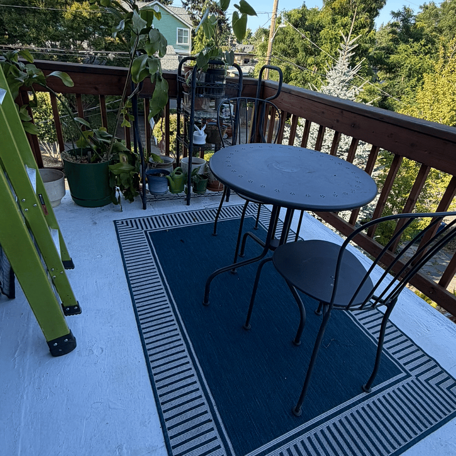 Upper balcony with outdoor seating and leafy outlook