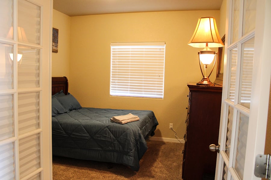 Bedroom #2 Queen Size bed, refrigerator, and microwave