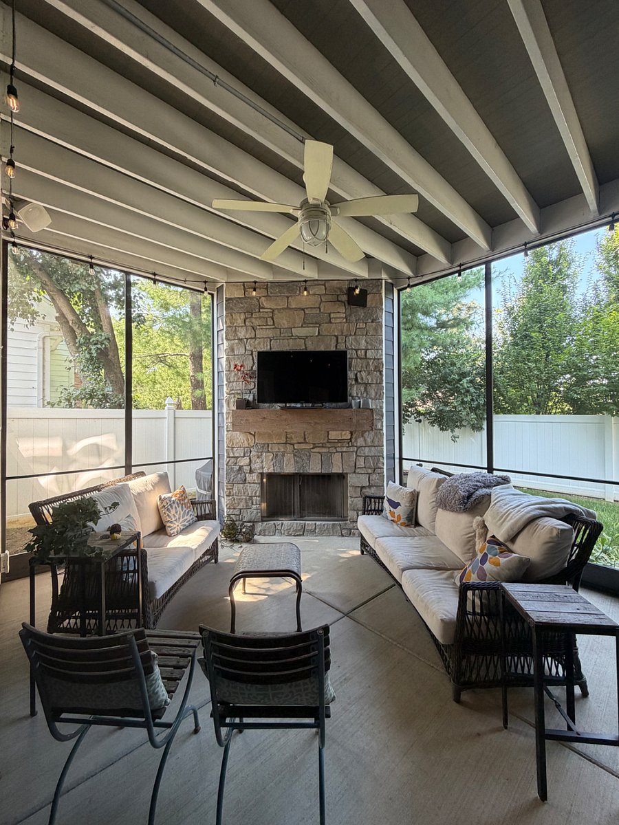 Shared screened-in back porch with wood burning fireplace.