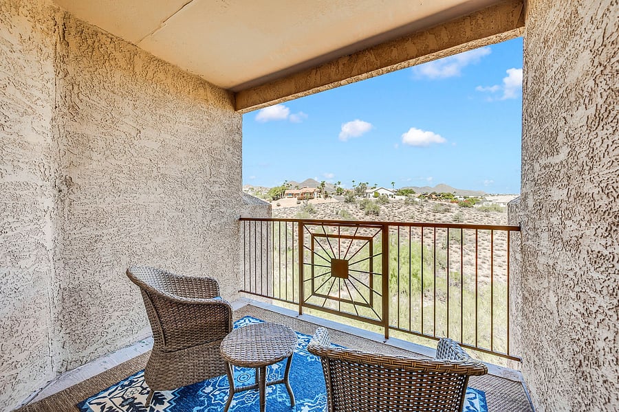 Private covered balcony with open desert and mountain views.