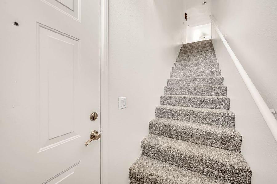 Private ground-level entrance with one flight of interior stairs leading to the condo.