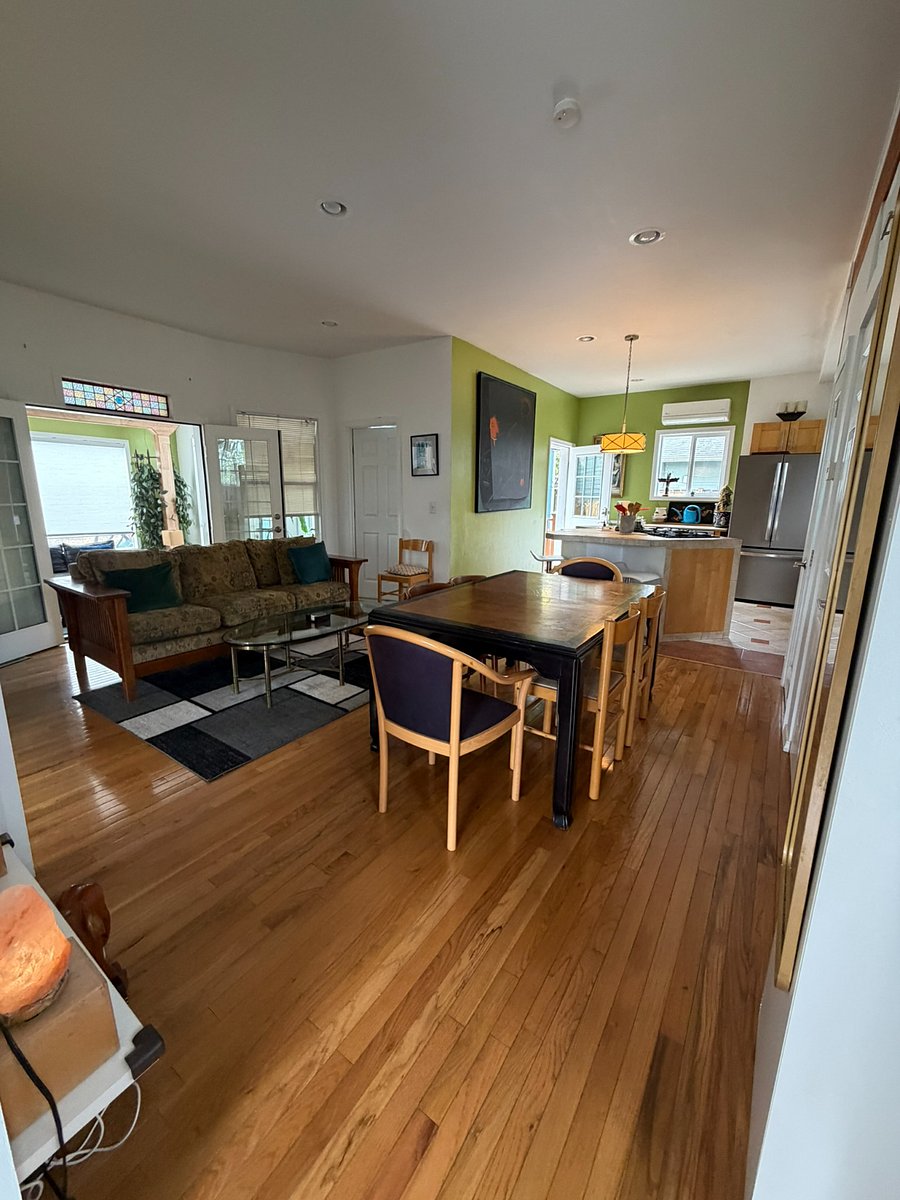 Open living and dining area with full kitchen beyond