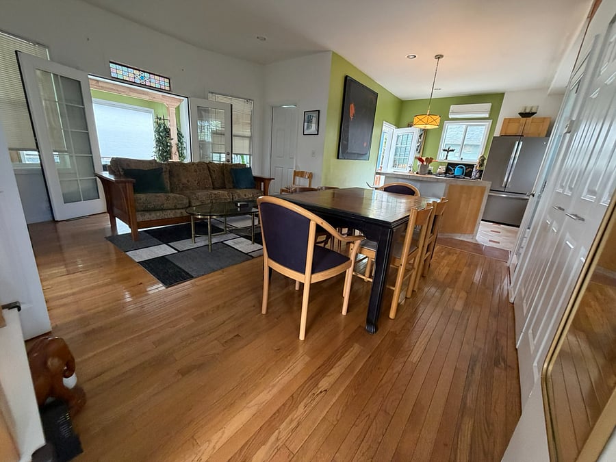 Open living and dining area with hardwood floors