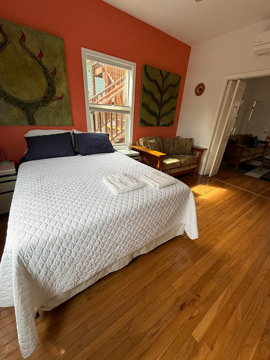 Main bedroom with queen bed and seating area