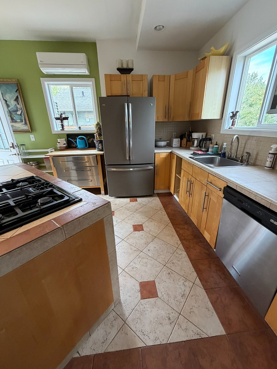 Full kitchen with newer refrigerator and dishwasher