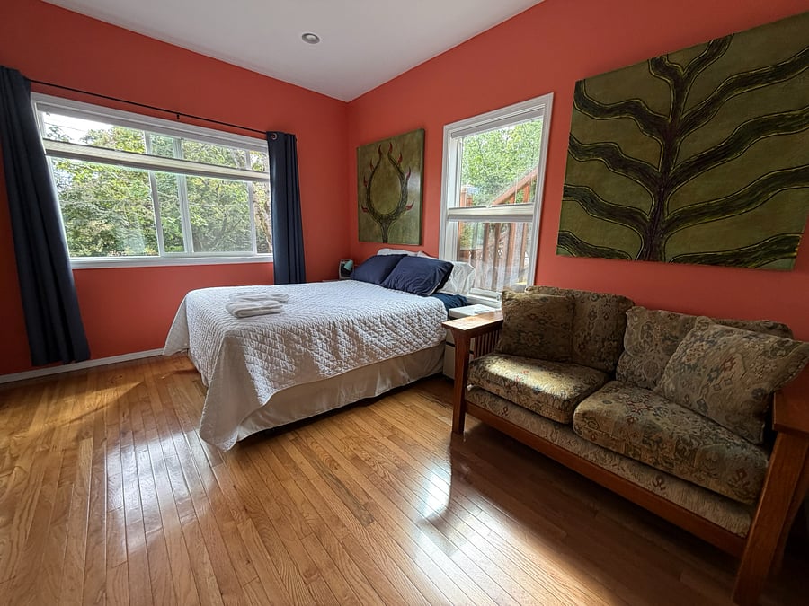 Spacious queen bedroom with comfortable seating