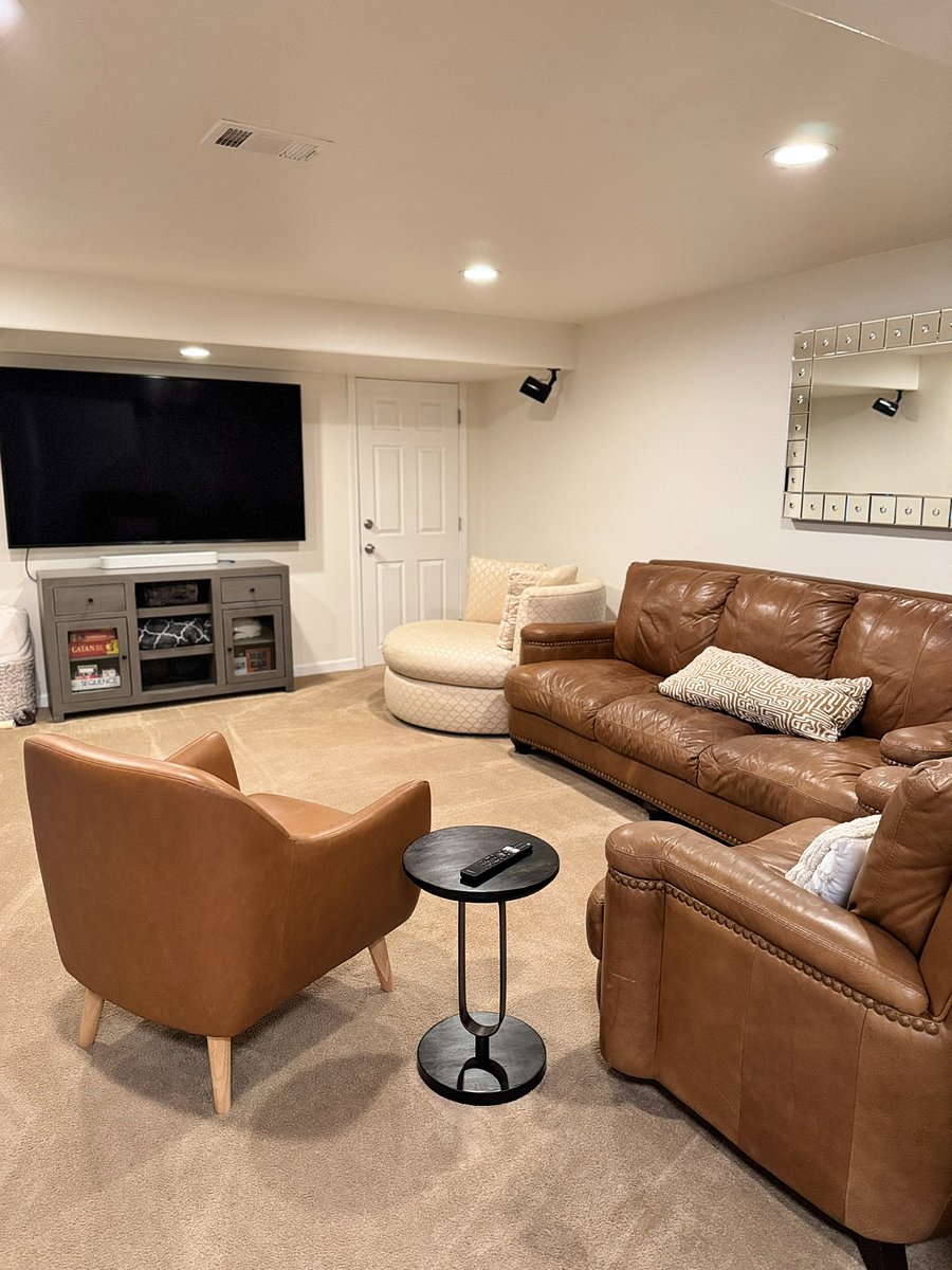Cozy basement with large TV and sound system