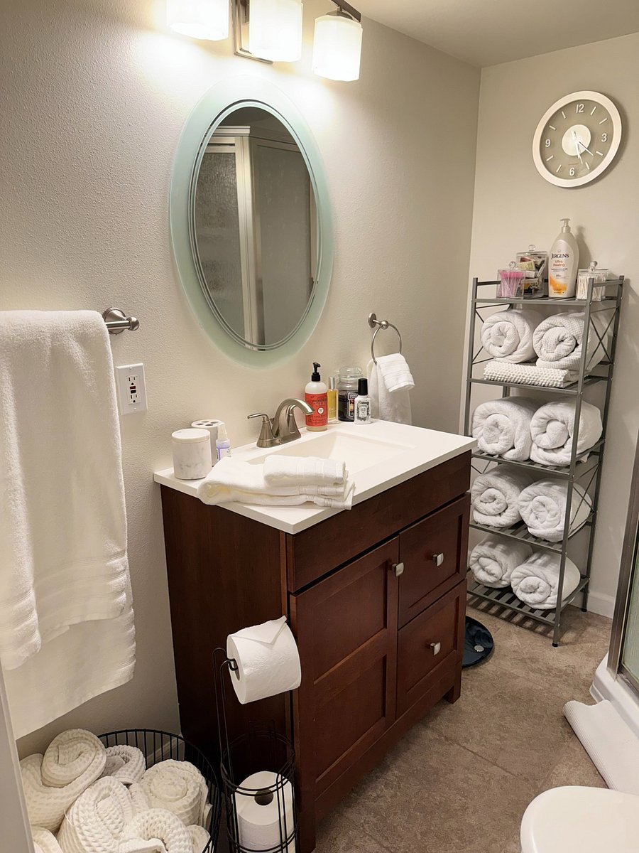 3/4 bathroom in the basement with a corner shower, fresh linens, and essential toiletries. Perfectly situated next to the basement king bedroom for a private-suite feel.