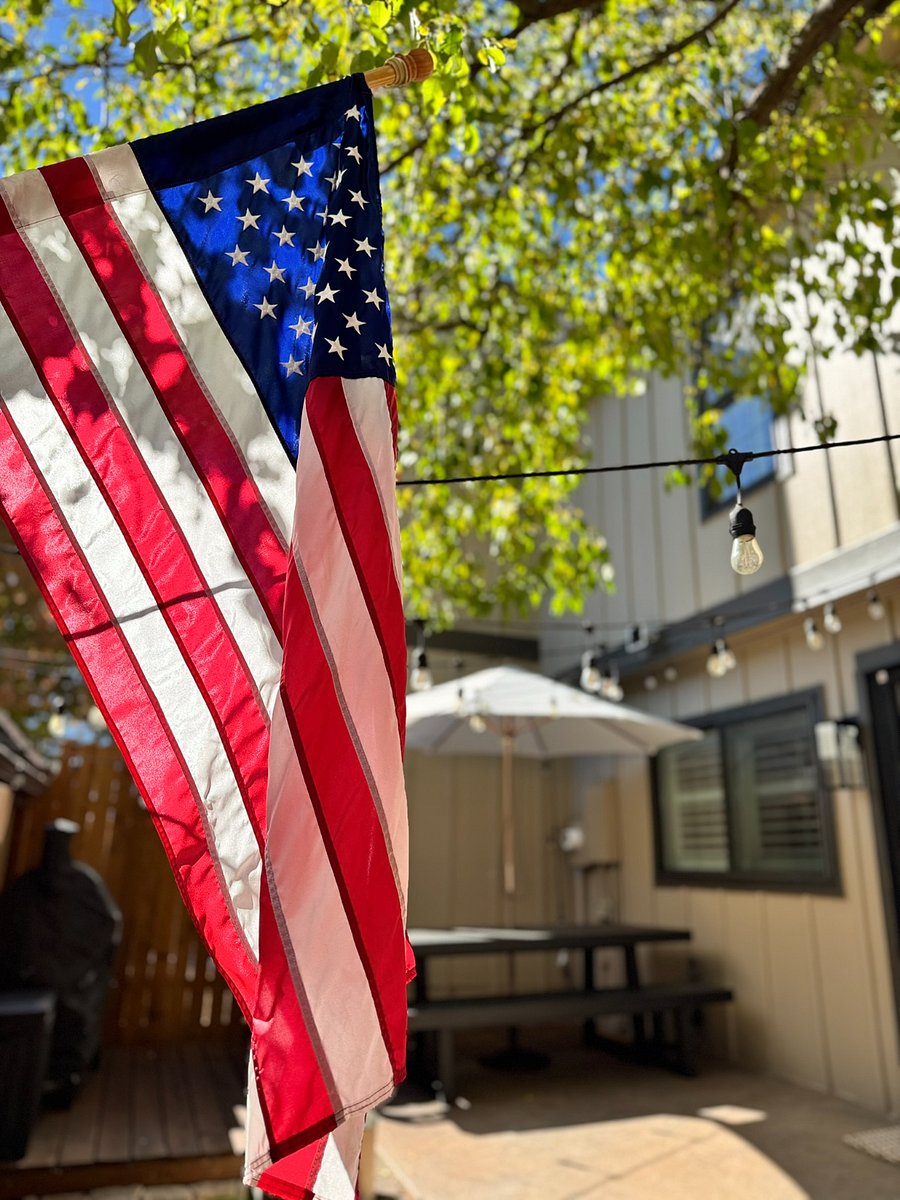 Private, fenced patio designed for effortless entertaining and relaxation. Features a Solo Stove fire pit, Traeger grill, string lights, and a shaded picnic table for al fresco dining or morning coffee.