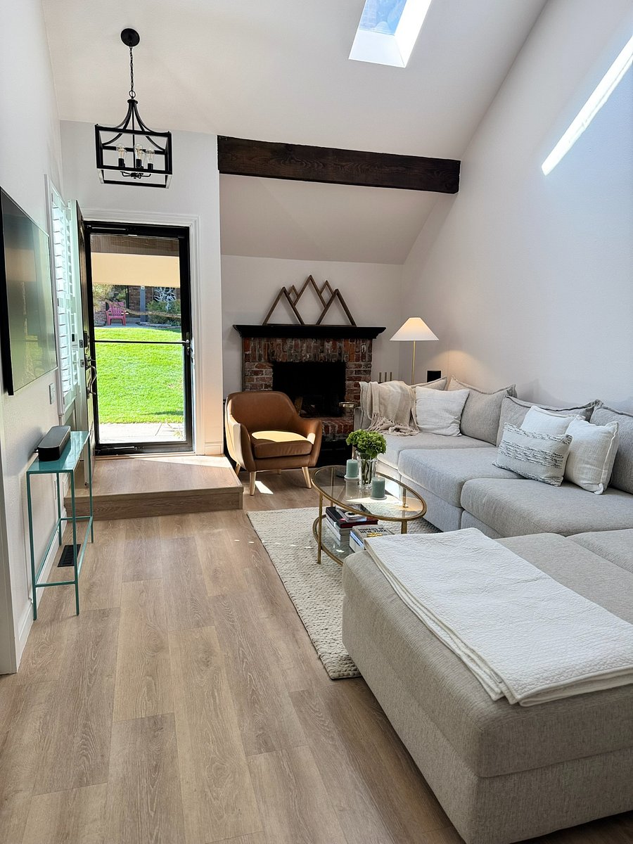 Oversized comfortable sectional and seating area with The Frame TV by Samsung and Sonos surround sound speaker system, decorative fireplace