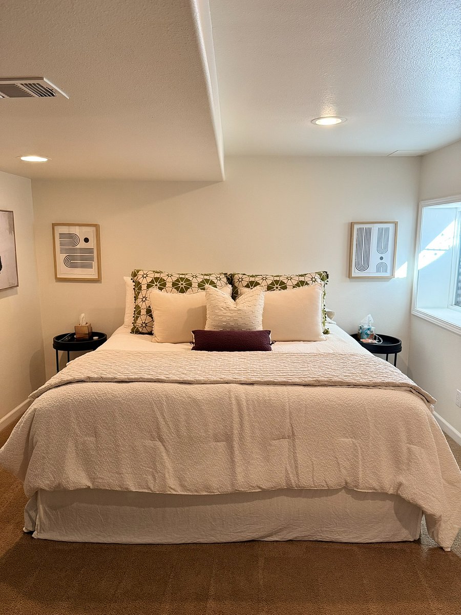 Basement bedroom with king size bed and luxurious bedding