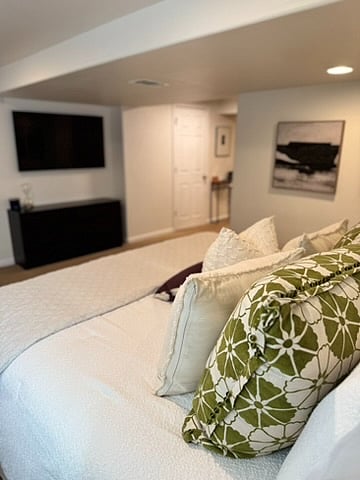 Basement bedroom with king bed and smart tv