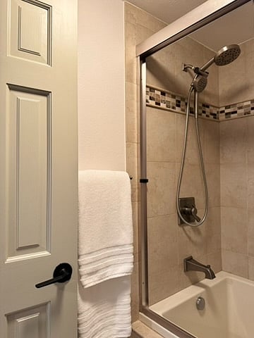 Tub shower with detachable handheld showerhead in upstairs king bedroom