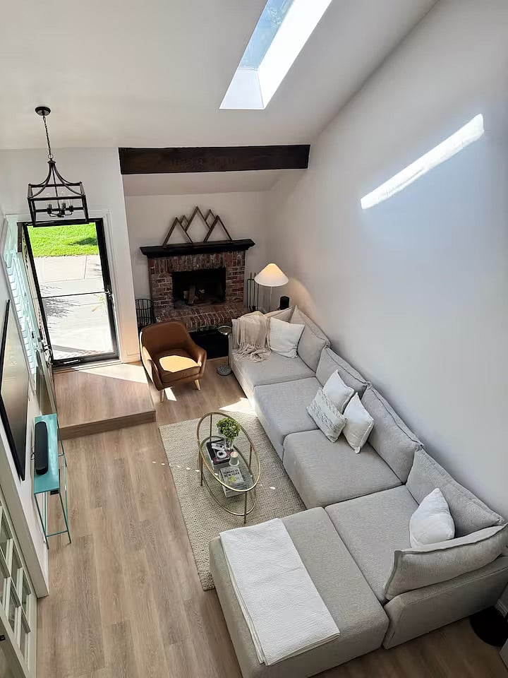 Oversized comfortable sectional and seating area with The Frame TV by Samsung and Sonos surround sound speaker system