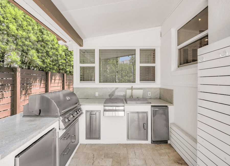 Outdoor kitchen (includes, grill, refrigerator, sink, garbage and beverage center