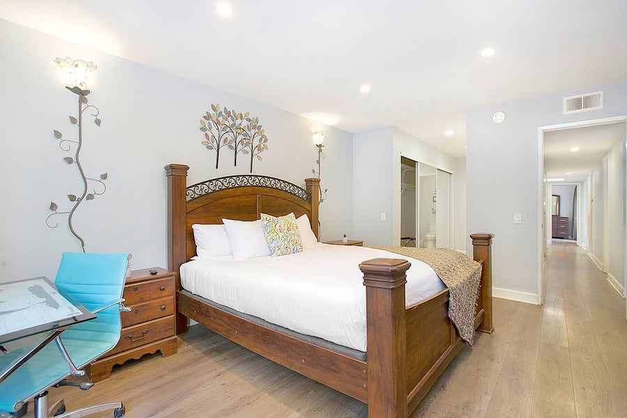 Rest and recharge in this cozy bedroom featuring a comfortable king-size bed, thoughtfully arranged to provide a peaceful and relaxing retreat throughout your stay.