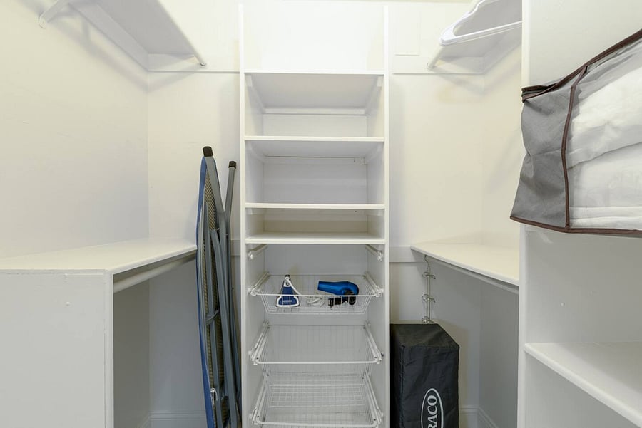 Walk-in closet. The house includes a Pack 'n Play, a vacuum, and an iron with an ironing board for your convenience.