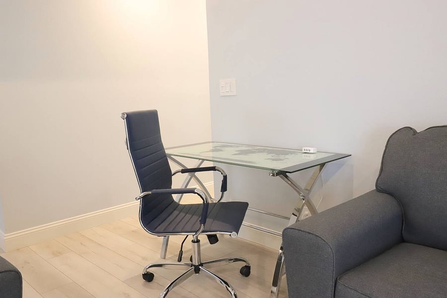 Computer desks/chairs are in the living area as well as the master bedroom