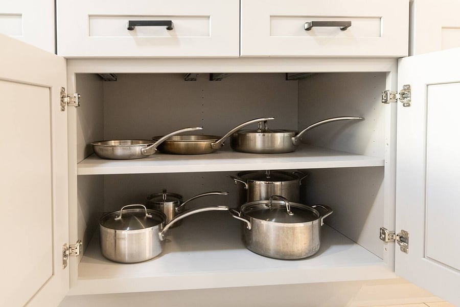 The kitchen is well stocked with cookware, utensils, silverware, and glassware.