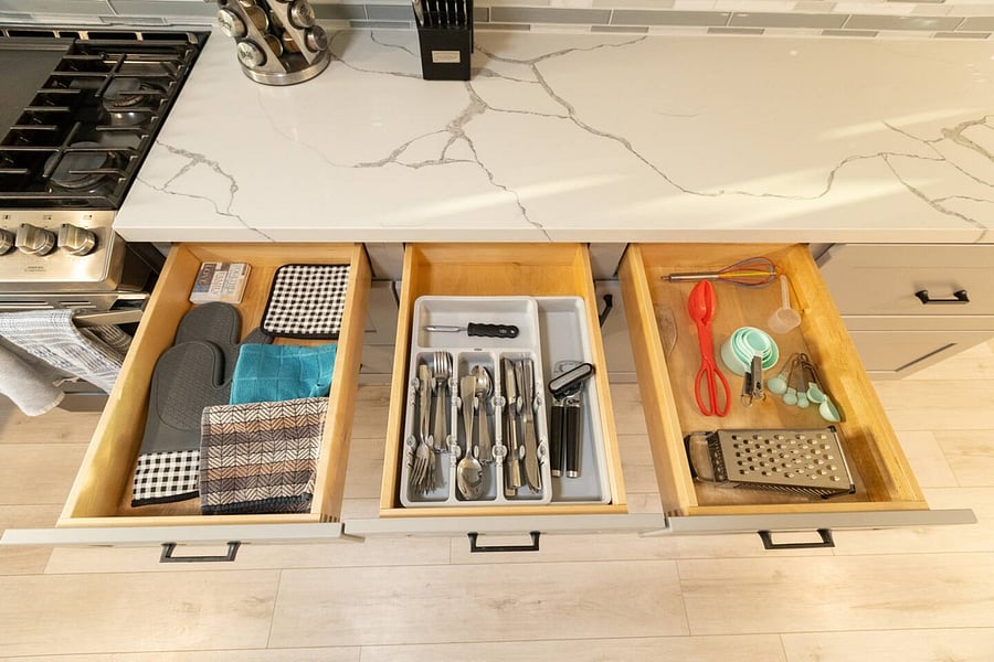 The kitchen is well stocked with cookware, utensils, silverware, and glassware.