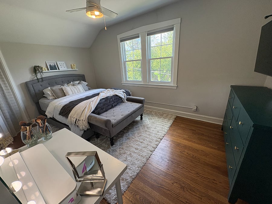 A bright bedroom with hardwood floors and good closet space.