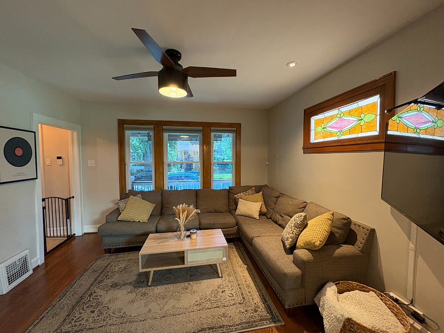 Original 1920s stained glass and a deep sectional, the spot to land at the end of the day.
