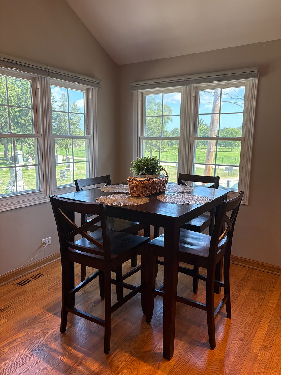 Morning coffee by the bay windows, looking out over green space.